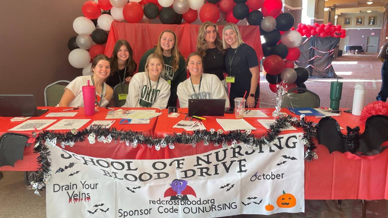 group of people in at decorative blood drive table