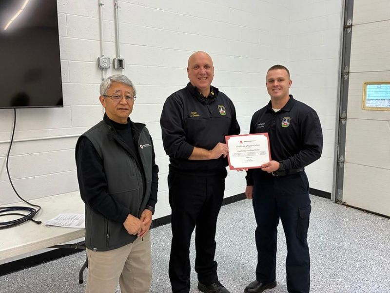 fire department chief holding award certificate