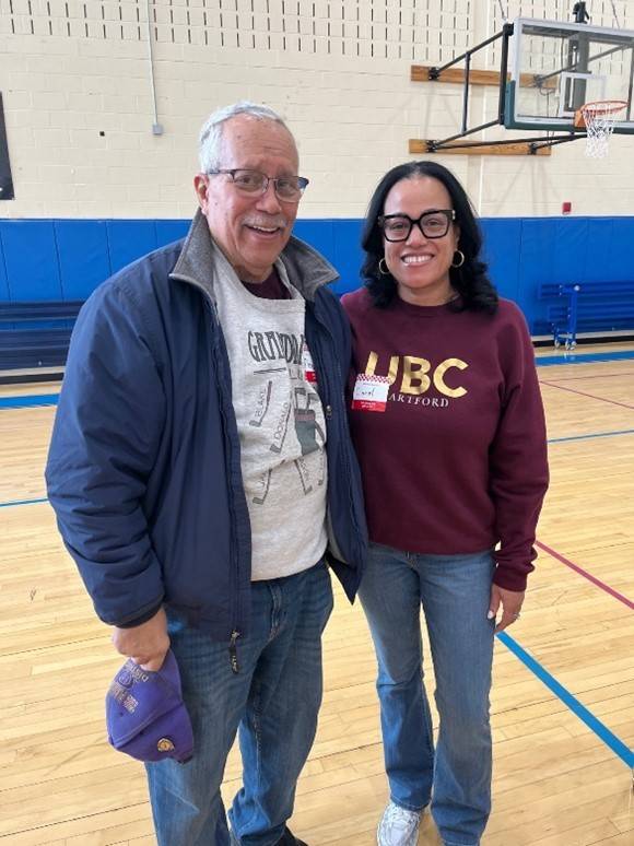Man stands next to woman in gymnasium