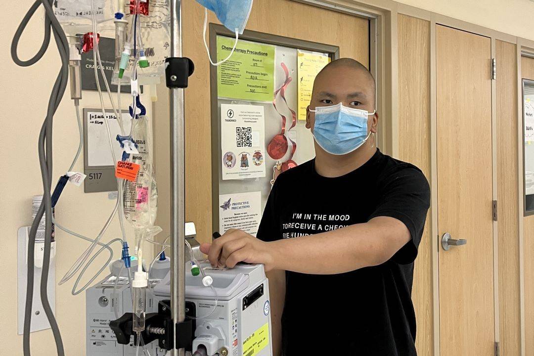 Man in hospital walking hallways with IV attached