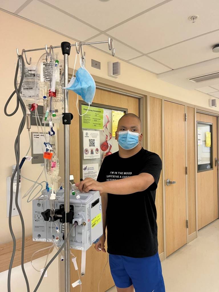 Male patient walking through hospital halls