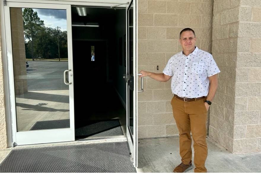 Man stands holding door to church open