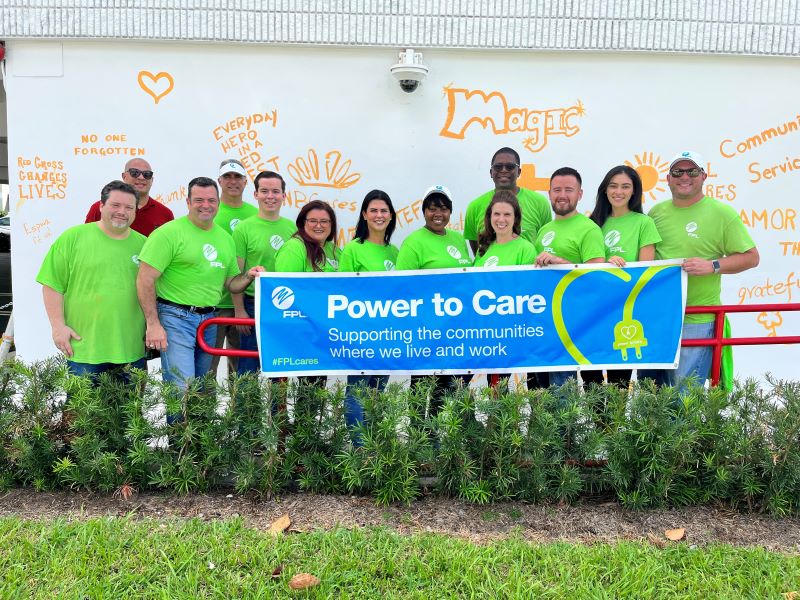 Group of people holding a "power of care" banner.