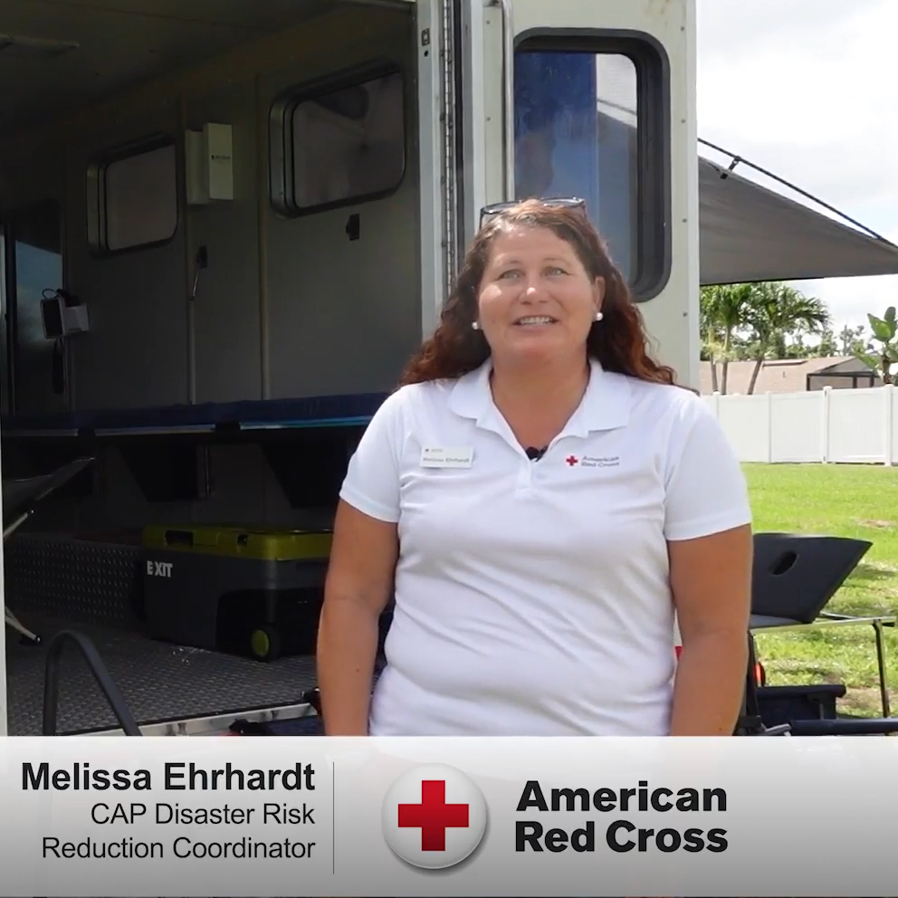woman stands in front of truck