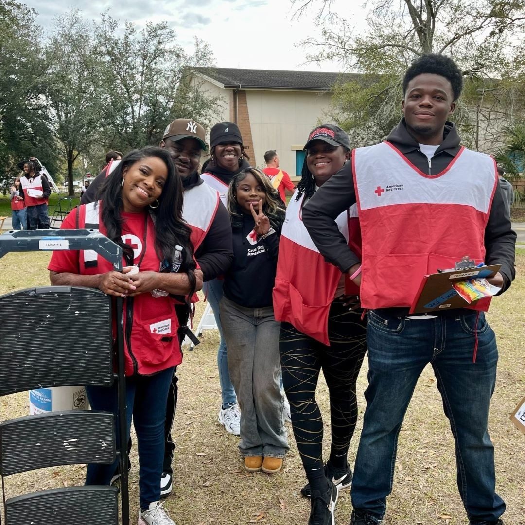 group of red cross volunteers with step stool 