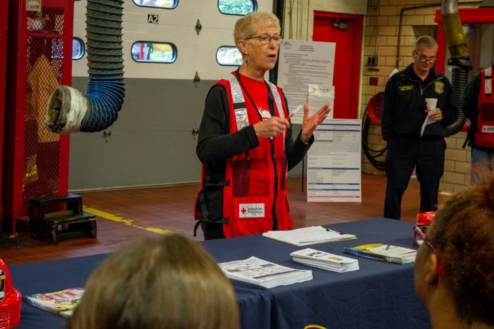 female volunteer talking to audience at table