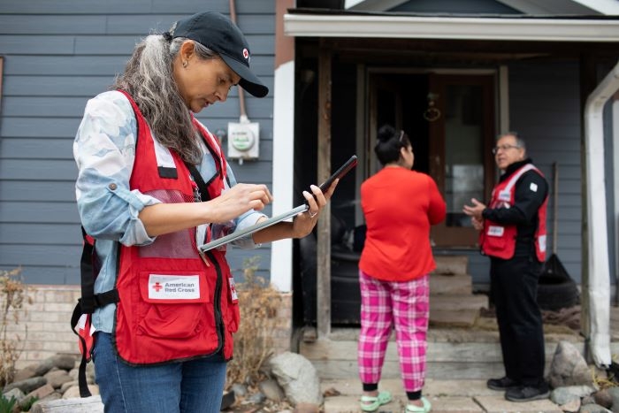 red cross volunteer talking to client