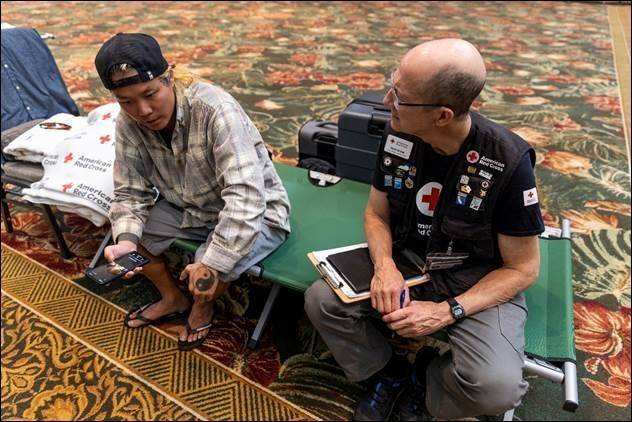 rich byam talking to red cross client in shelter 