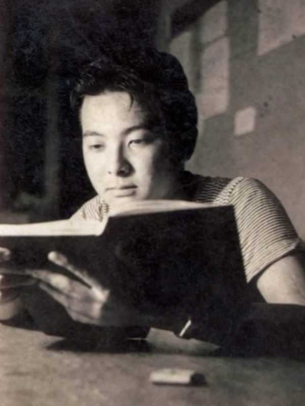 black and white young man reading a book