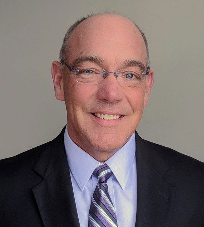 a man with a blur blazer and white and blue striped toe