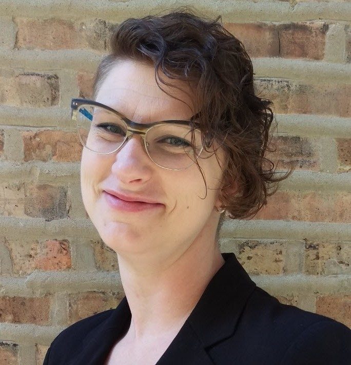 image of woman wearing glasses in a black blazer