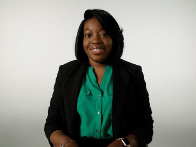 woman in green and black professional attire