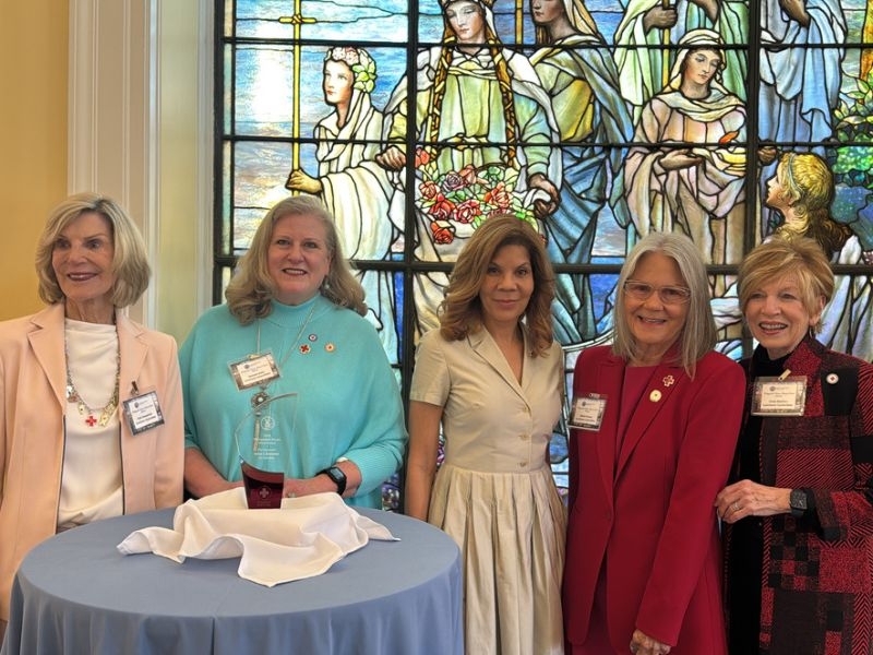 women in front of tiffany circle windows