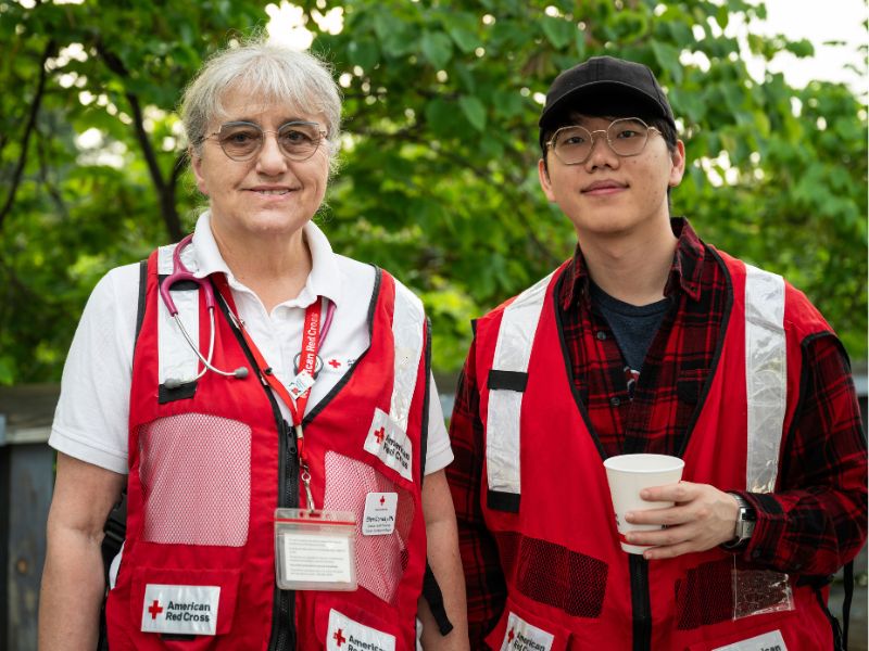 volunteers holding cup of water