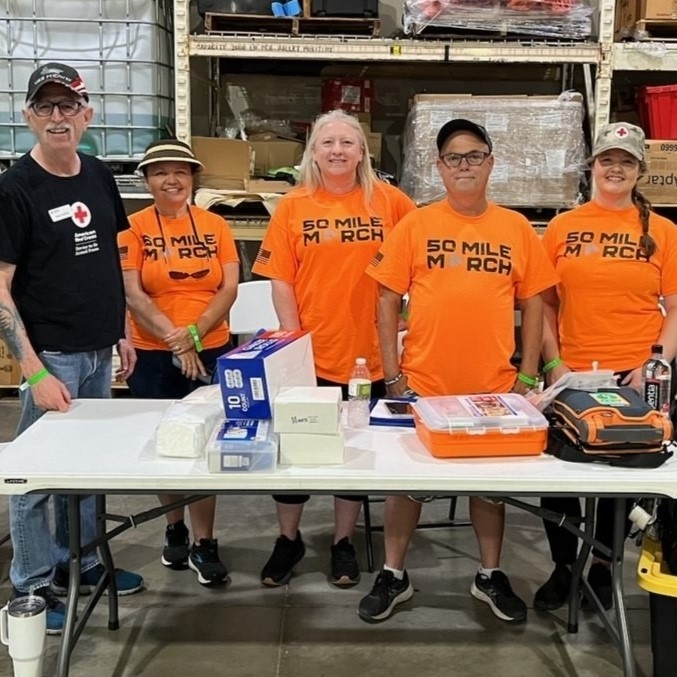group of people stand behind table