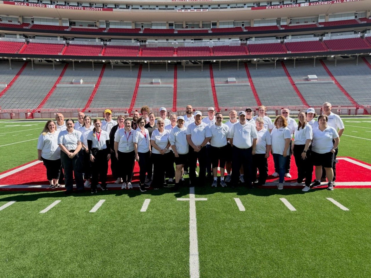 group of red cross volunteers standing on a football field