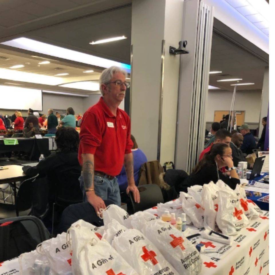 ken at pop-up table with goodie bags