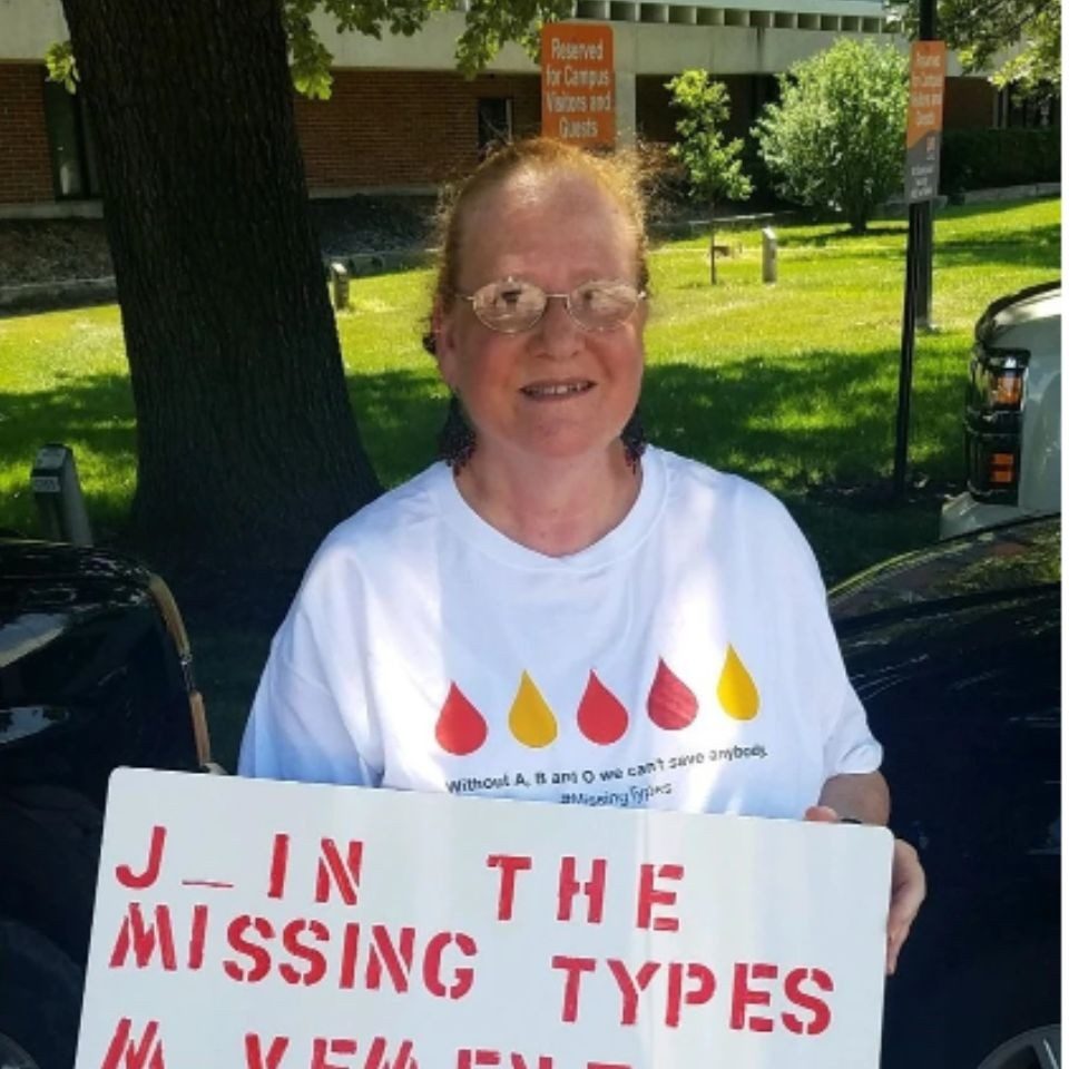 wanda holding up signage