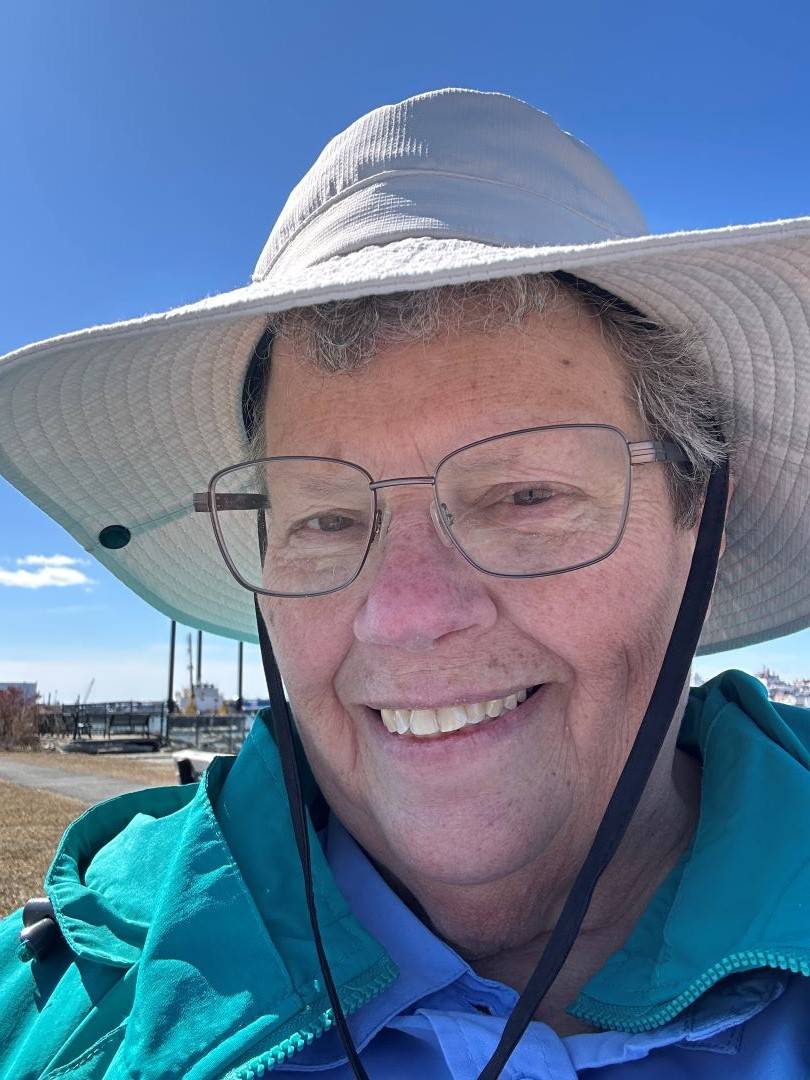 Deborah wears sun hat while walking outside