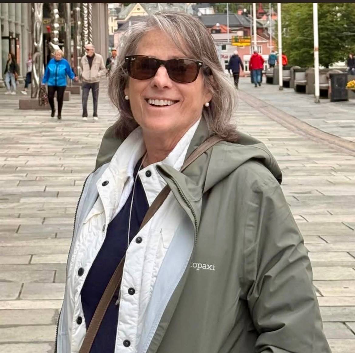 Woman smiles while standing in city