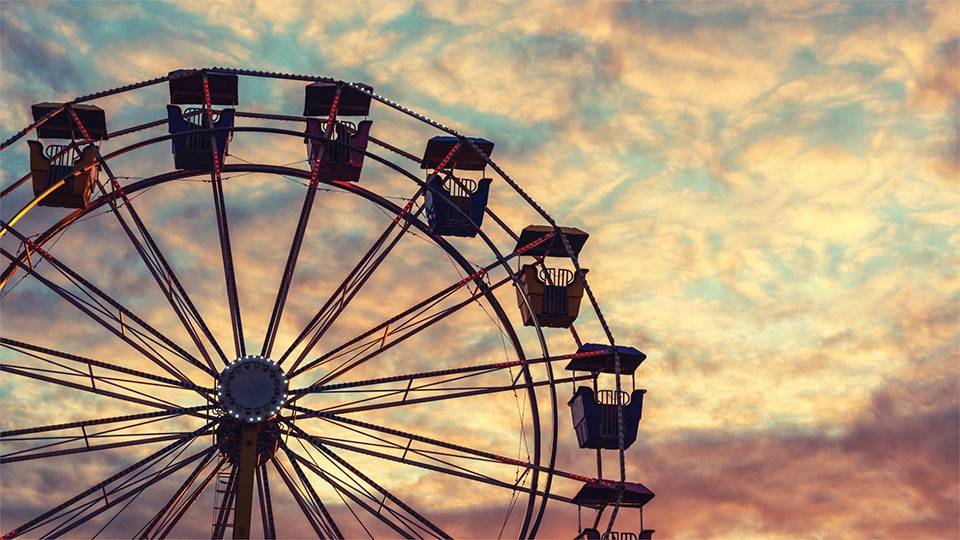 Ferris wheel with cloudy sky in background