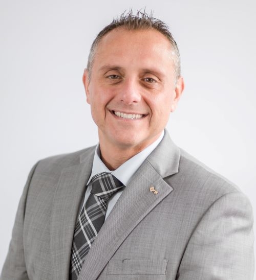 man in gray blazer and striped blue and white tie