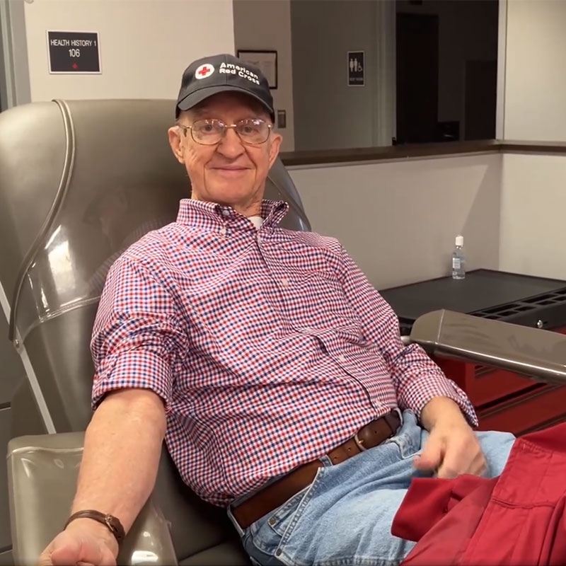 Ernest Moody sitting in chair ready to donate blood.