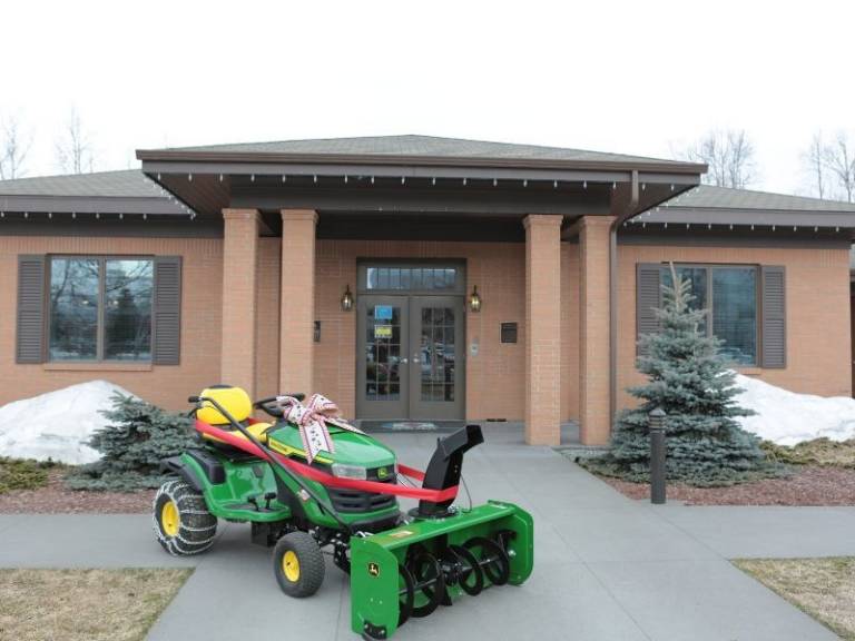 john deere tractor in front of alaska fisher house