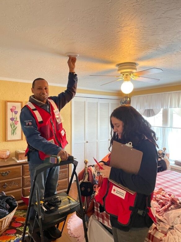 Two individuals intalling smoke alarms