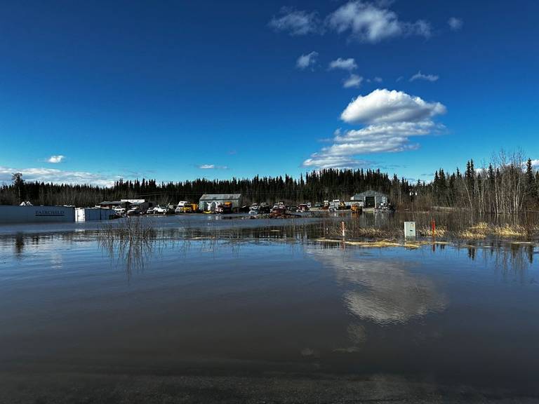 Flooding in Yukon with houses and vehicles