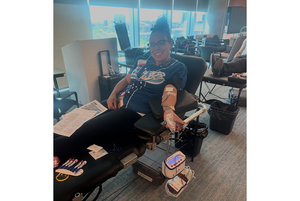 Angelena Fly sitting in a chair donating blood.