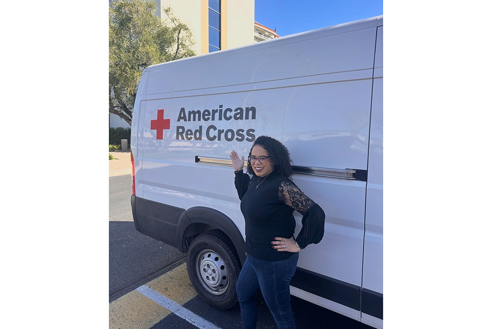 Angelena Fly standing next to a Red Cross van.