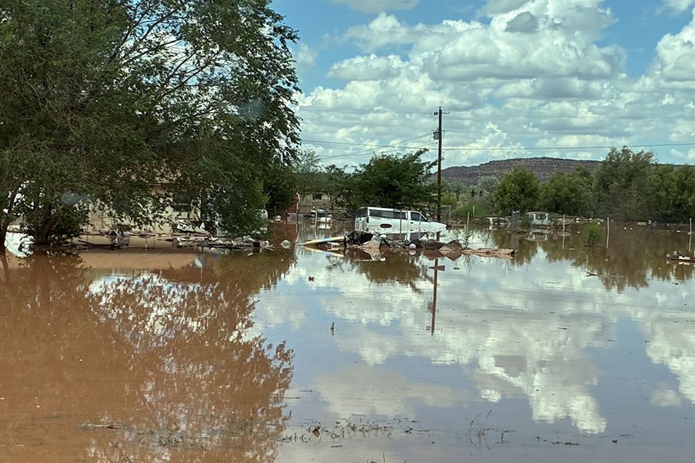 flooded area with a truck in the middle of the flood waters.