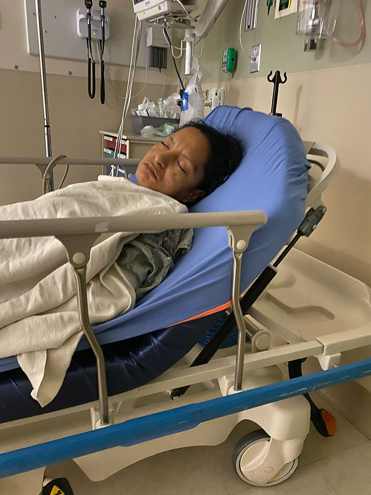 Reina Nunez sleeping in a hospital bed.