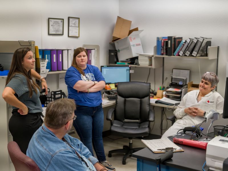 courtney in meeting with others.
