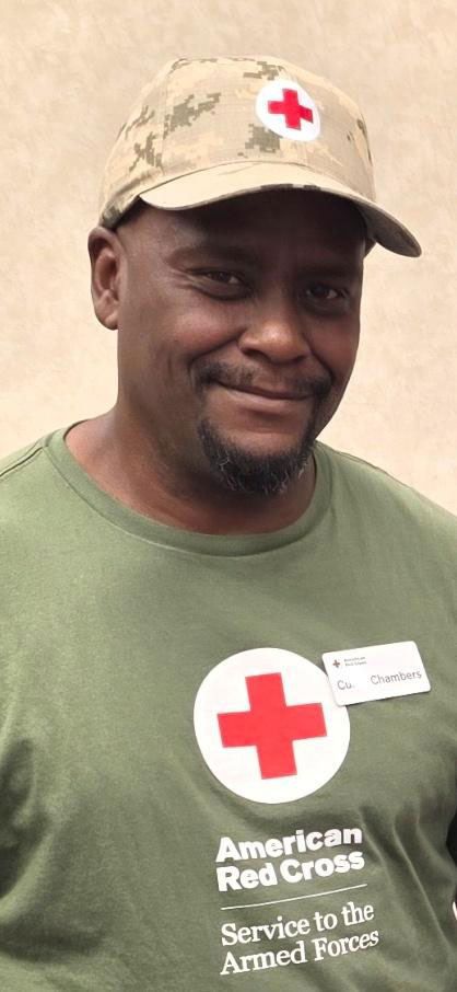 Curtis Chambers wearing a Red Cross hat and shirt.