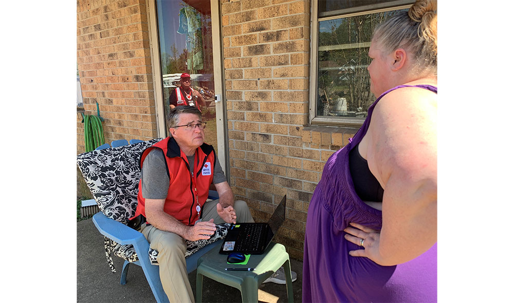 Red Cross caseworker talks to Connie Kiester