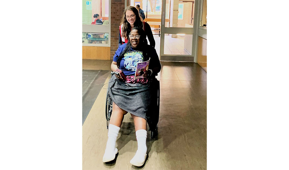 Red Cross volunteer helping woman in wheelchair