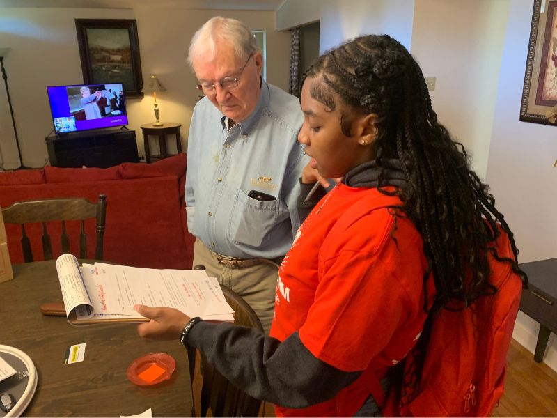blytheville-volunteers-sta-2 - 1 volunteer reviewing checklist with resident