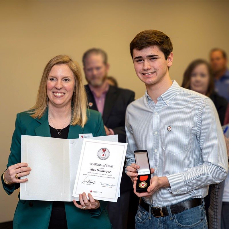 Alex Dallmeyer showing American Red Cross Certificate of Merit.