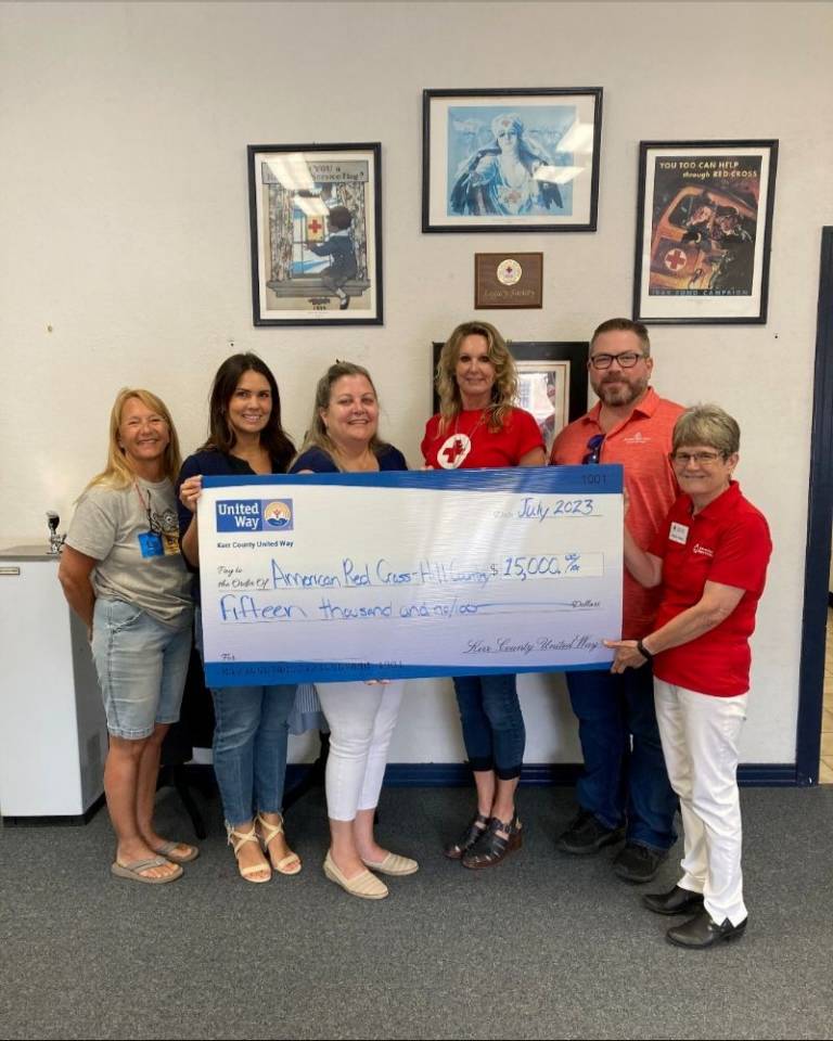 A group of peopleholding a large check.
