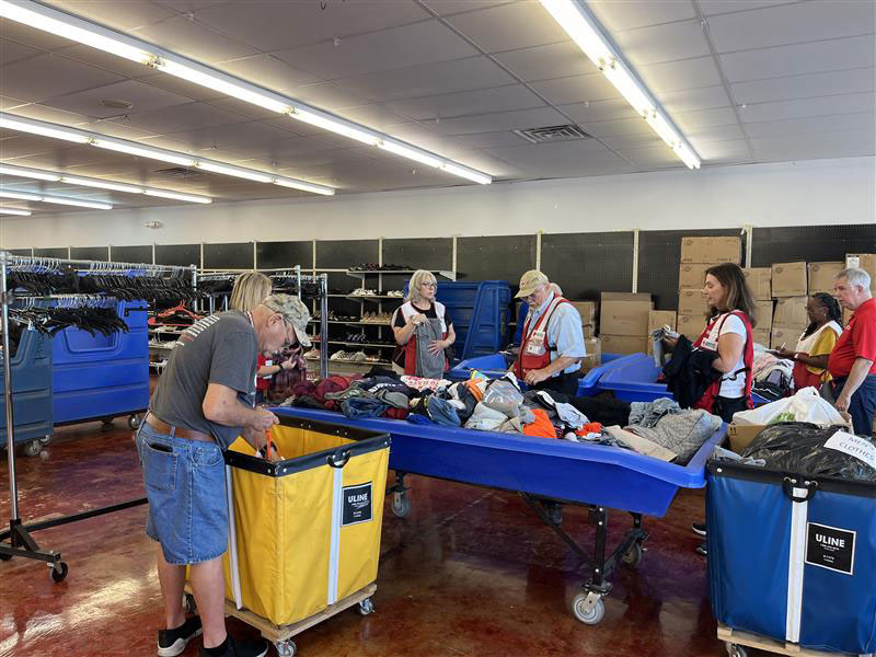 Red Cross volunteers working in a warehouse.