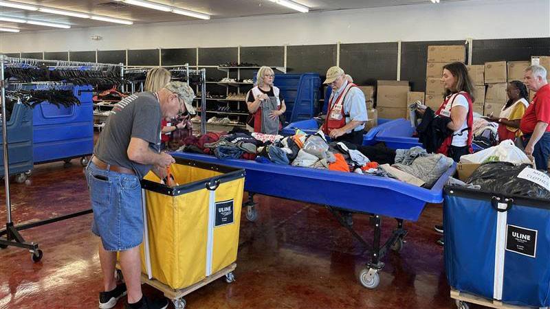 Red Cross volunteers working in a warehouse.