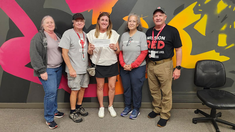 Group picture of 5 people with one holding up a Client Assistance letter.