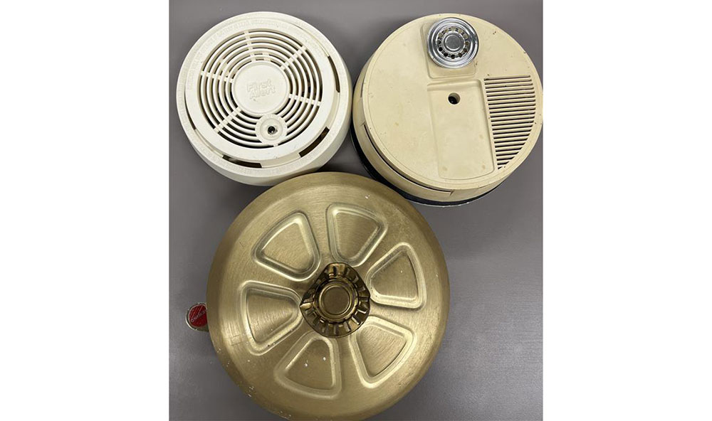 collection of old smoke alarms.
