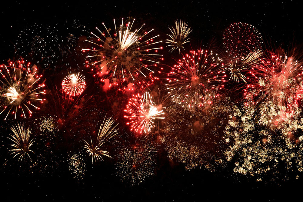 Fireworks exploding in the night sky.