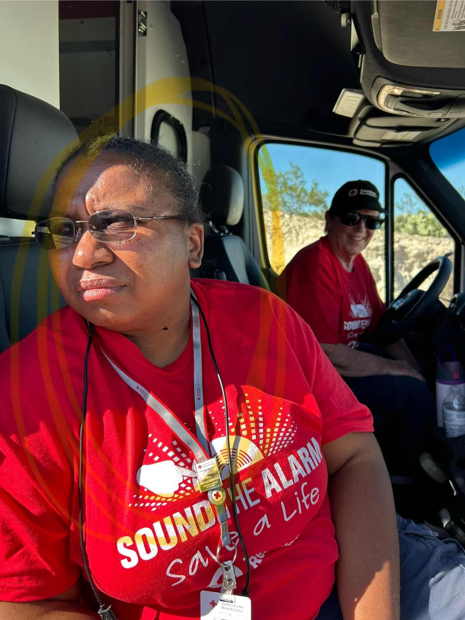 Magella Oriental in vehicle with another red cross volunteer