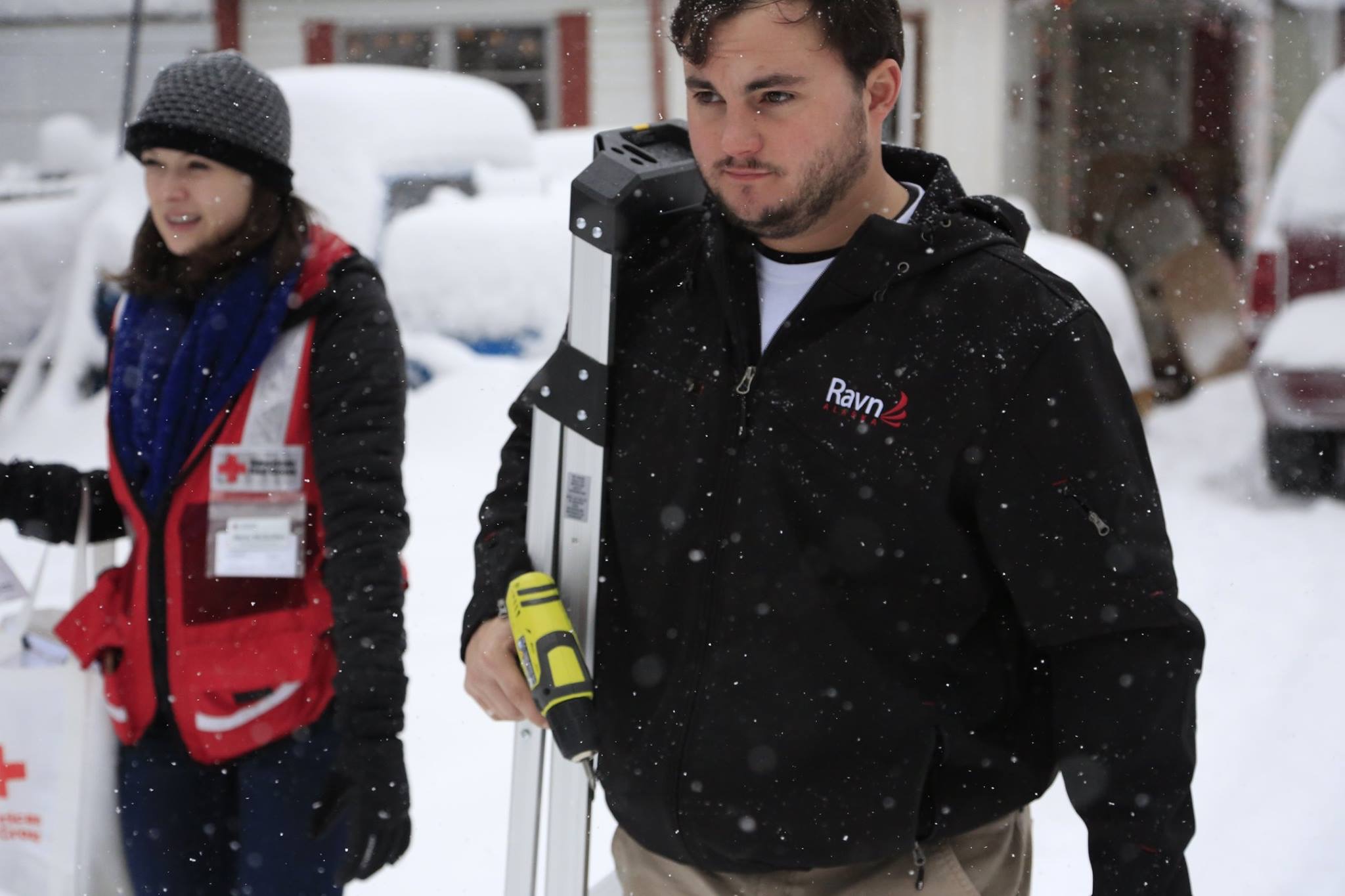 william carrying ladder and drill in the snow