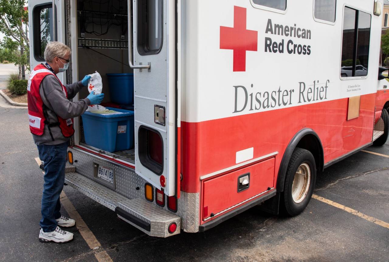 April 18, 2020.  Monroe, Louisiana.
Charles "Harry" Murphy, Jr., BS, NRP the Emergency Management Coordinator for the Louisiana Region, Cap/West Chapter, prepares bags of masks and hand sanitizer in the back of an Emergency Response Vehicle for people sheltered at a hotel because of a recent tornado in Monroe, LA, on Saturday, April 18, 2020. Normally the Red Cross would set up shelters, but due to the pandemic and social distancing guidelines, people who were unable to stay in their homes have been given rooms in various local hotels.
Photo by Scott Dalton/American Red Cross