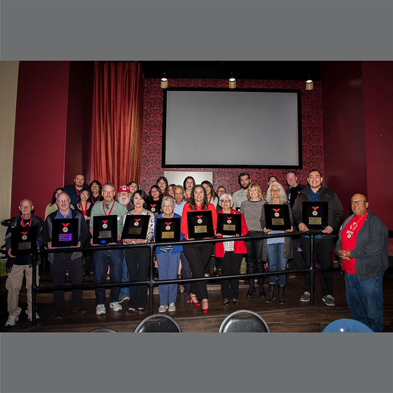 Red Cross volunteers holding award.